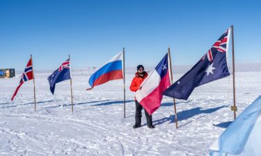 Chile’s President Gabriel Boric displays his country's flag at the South Pole on Friday