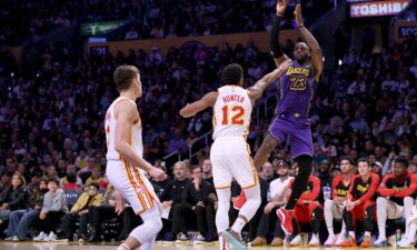 LeBron James scoring on a jumper over De'Andre Hunter and Bogdan Bogdanovic of the Atlanta Hawks. James set another record on Friday as he surpassed the legendary Michael Jordan’s mark for the most 30-point games in NBA history.