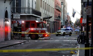 A fire truck and a police vehicle operate near the site where people were killed by a man driving a truck in an attack during New Year's celebrations