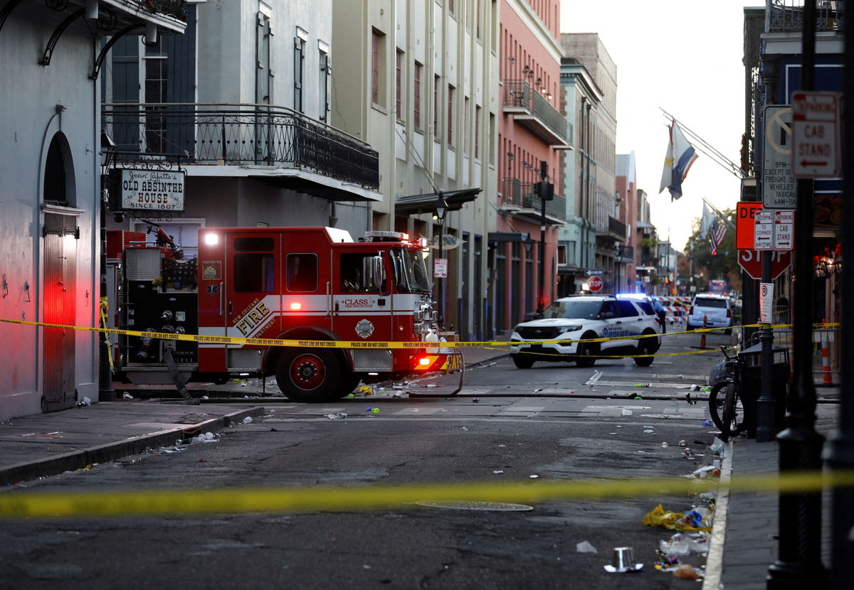 <i>Octavio Jones/Reuters via CNN Newsource</i><br/>A fire truck and a police vehicle operate near the site where people were killed by a man driving a truck in an attack during New Year's celebrations