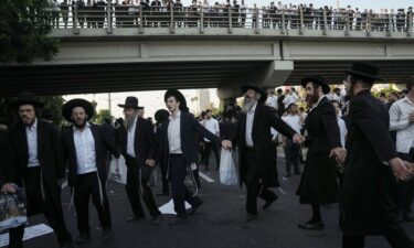 Ultra-Orthodox Jewish men block a highway during a protest against army recruitment in Bnei Brak