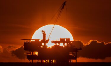 An offshore oil platform is seen at sunset near Huntington Beach