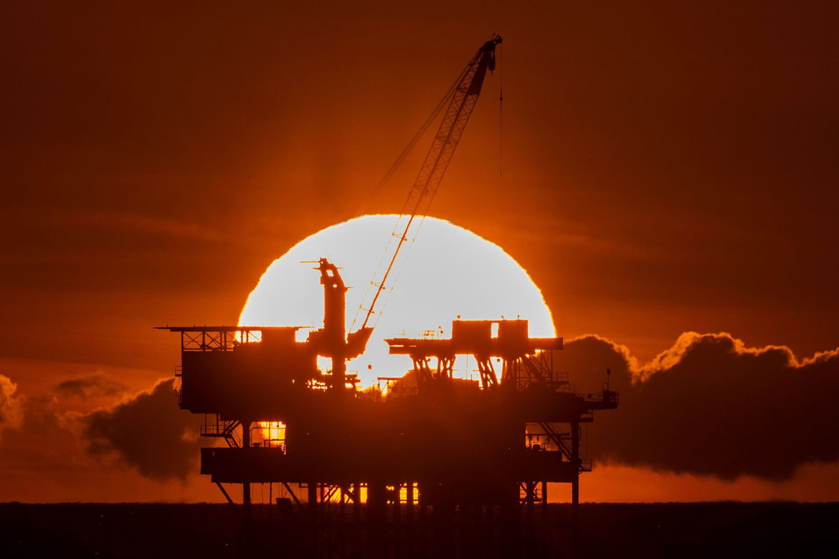 <i>David McNew/Getty Images via CNN Newsource</i><br/>An offshore oil platform is seen at sunset near Huntington Beach