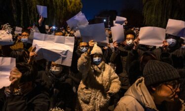 Protesters hold up pieces of white paper to symbolize censorship during a protest against China's strict zero Covid measures in Beijing