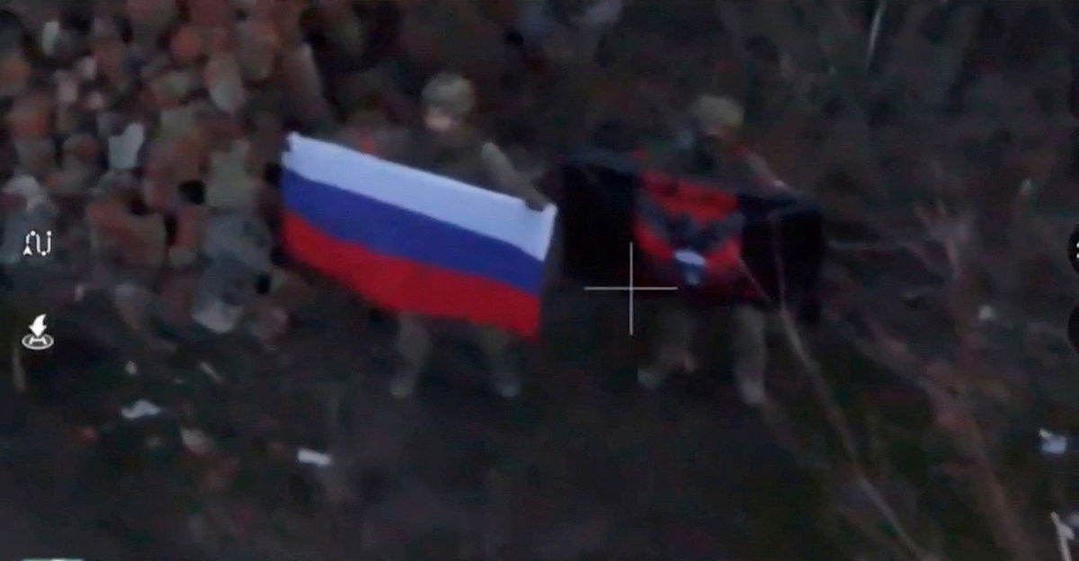 <i>Reuters via CNN Newsource</i><br/>An image taken from social media shows a soldier holding a Russian flag in Kurakhove