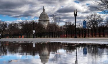 The Dome of the U.S. Capitol Building is visible as new temporary protective fencing is erected near the West Front of the U.S. Capitol Building on January 1 in Washington