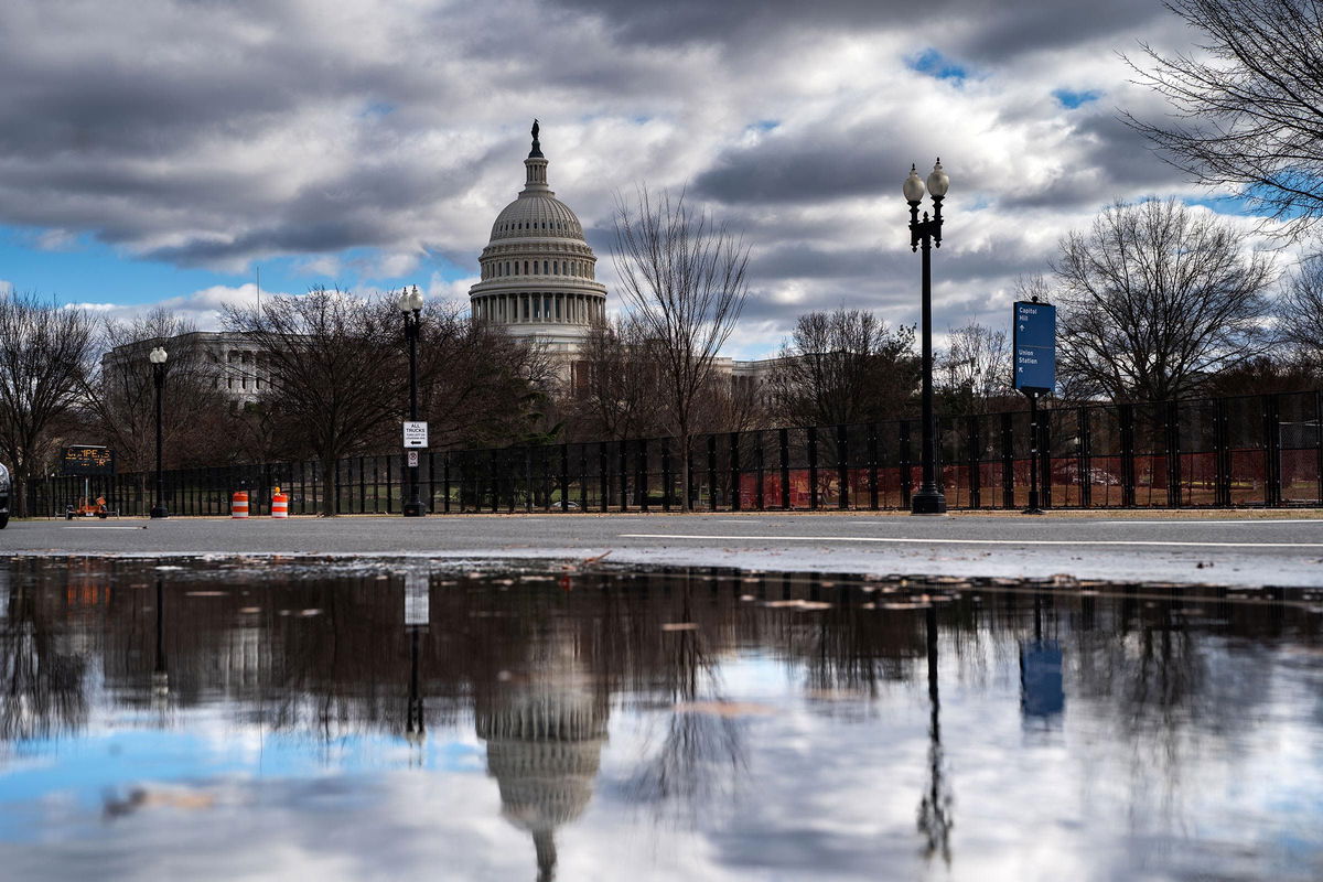 <i>Kent Nishimura/Getty Images via CNN Newsource</i><br/>The Dome of the U.S. Capitol Building is visible as new temporary protective fencing is erected near the West Front of the U.S. Capitol Building on January 1 in Washington