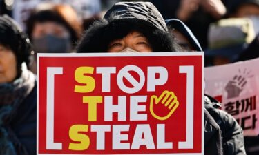 Protesters with both American and South Korean flags and 'Stop the Steal' placards gather to show support for the impeached-President Yoon Suk Yeol