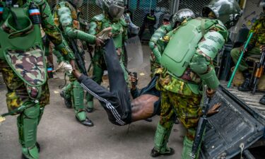 Kenyan police officers intervene during June's protests against controversial tax plans.