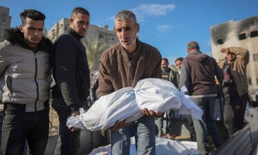 The body of an 18-month-old is carried by her uncle for burial in the aftermath of an Israeli airstrike in Khan Younis