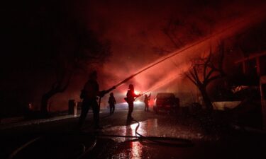 Firefighters battle flames from the Palisades Fire on January 8