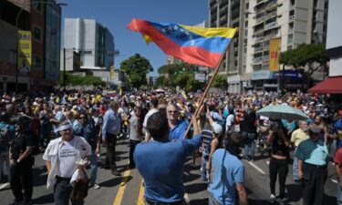 A demonstrator waves a Venezuelan flag at an opposition protest in Caracas on January 9.