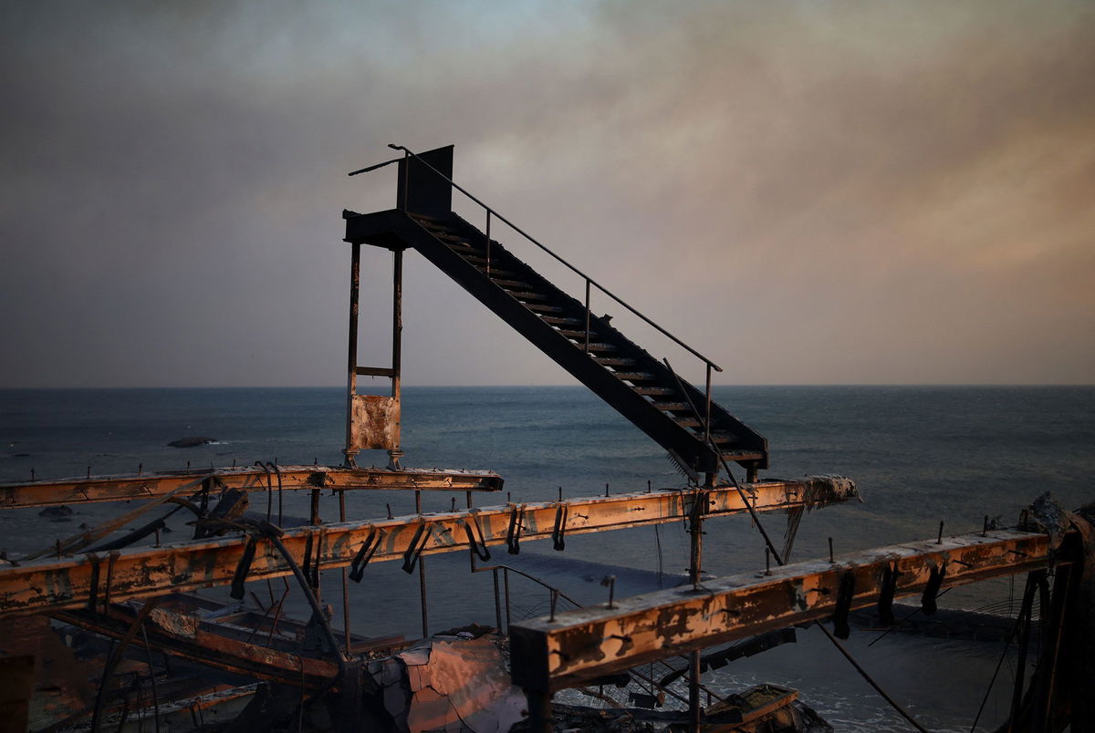 <i>Daniel Cole/Reuters via CNN Newsource</i><br/>A staircase remains standing amid the ruins of a burnt structure along the Pacific Coast Highway in Malibu