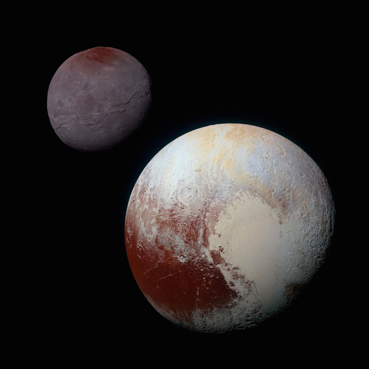 <i>NASA/Johns Hopkins University Applied Physics Laboratory/Southwest Research Institute via CNN Newsource</i><br/>A composite of enhanced color images showcase Pluto (lower right) and its large moon Charon (upper left)