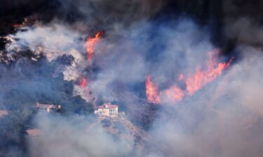 A house is threatened as the Palisades Fire grows in the mountains in the community of Topanga