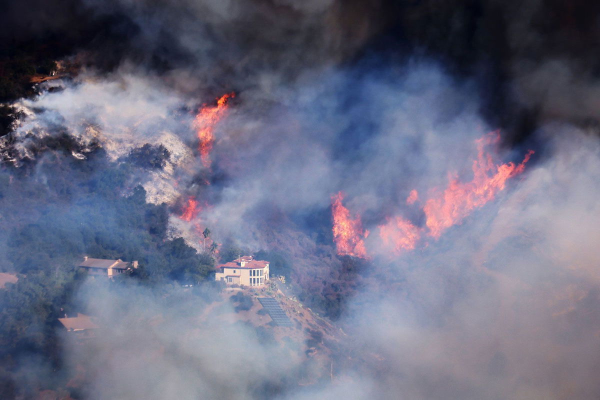 <i>David Swanson/AFP/Getty Images via CNN Newsource</i><br/>A house is threatened as the Palisades Fire grows in the mountains in the community of Topanga