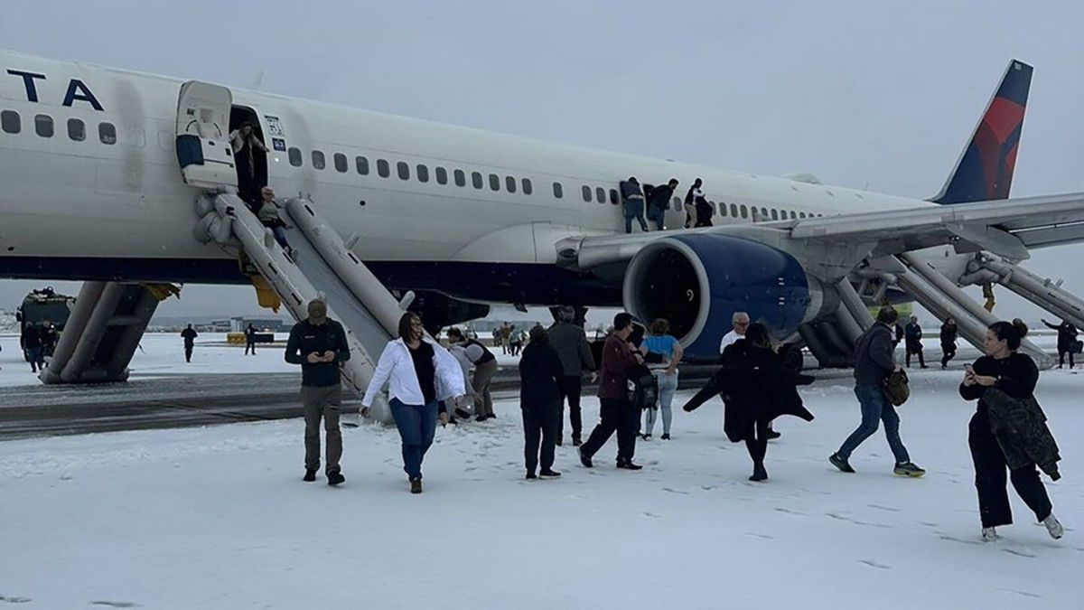 <i>courtesy Curtis James via CNN Newsource</i><br/>Passengers exit a Delta airplane at Hartsfield-Jackson Airport in Atlanta after an emergency on the runway on Friday