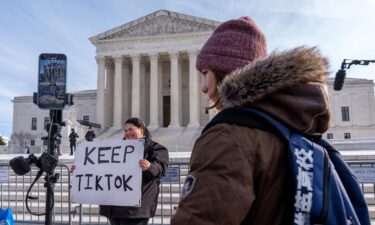 Callie Goodwin of South Carolina holds a sign in support of TikTok outside the Supreme Court on Friday