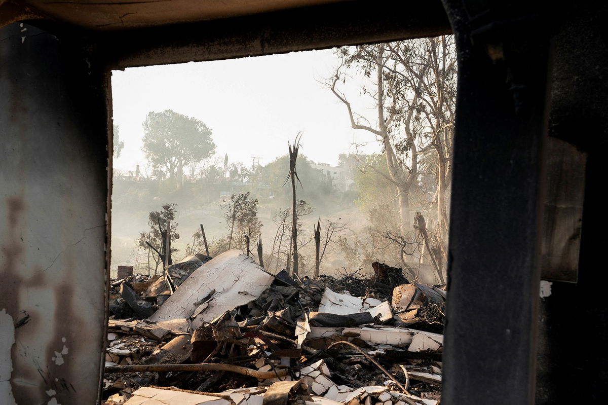 <i>David Ryder/Reuters via CNN Newsource</i><br/>The remains of a home following the Palisades Fire in the Pacific Palisades neighborhood of Los Angeles on January 10.