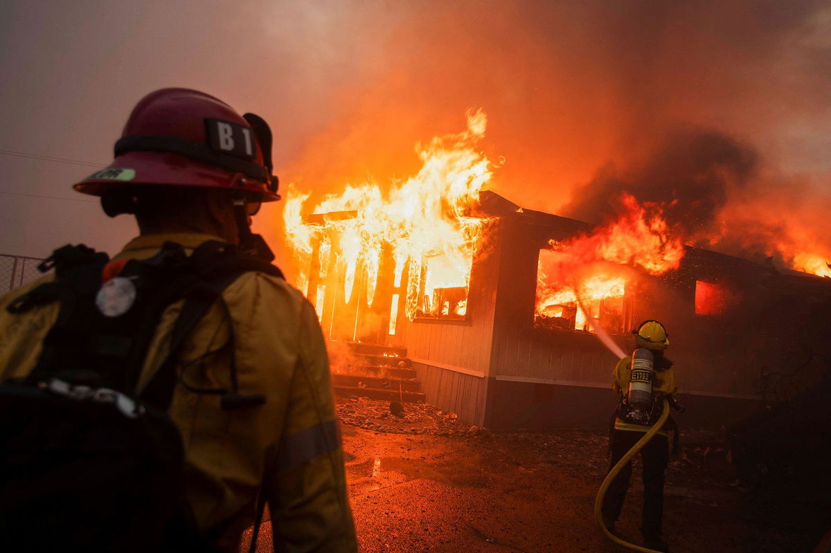 <i>Ringo Chiu/Reuters via CNN Newsource</i><br/>Firefighters work to extinguish the Palisades Fire during a windstorm on the west side of Los Angeles