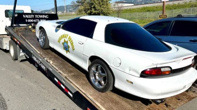 <i>San Rafael Police Department/KPIX via CNN Newsource</i><br/>A Chevrolet Camaro with CHP decals being towed after San Rafael police arrested the driver for allegedly impersonating a police officer