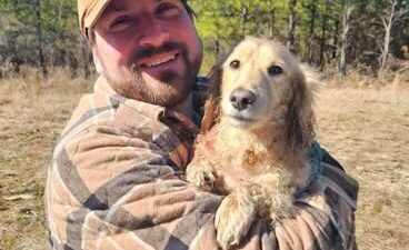 Matt Hemingway holds Teddy soon after he was pulled from an ice-covered pond in Stonewall.