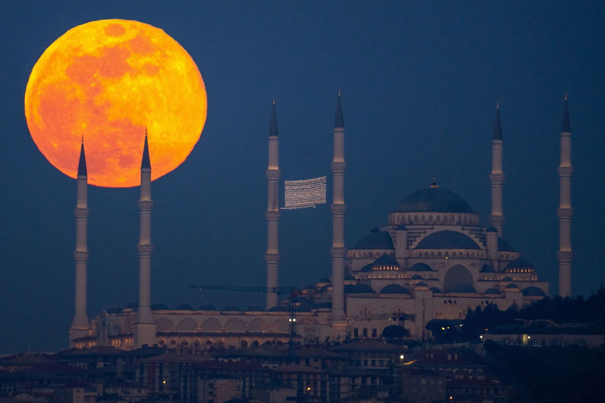 <i>Emrah Gurel/AP/File via CNN Newsource</i><br/>A full moon rises behind the Camlica mosque in Istanbul