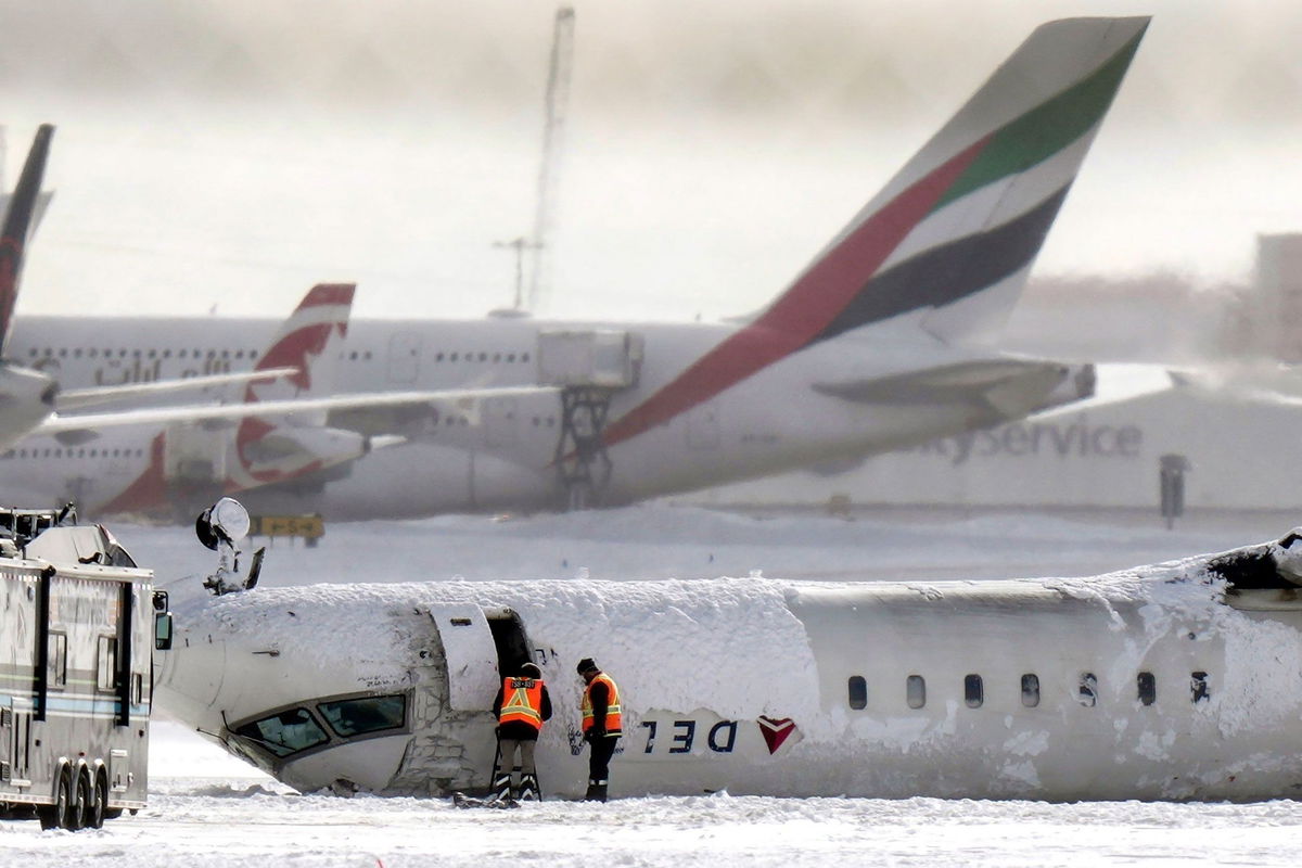 <i>Chris Young/The Canadian Press/AP via CNN Newsource</i><br/>Delta Air Lines Flight 4819 lies upside down at Toronto Pearson Airport on February 18