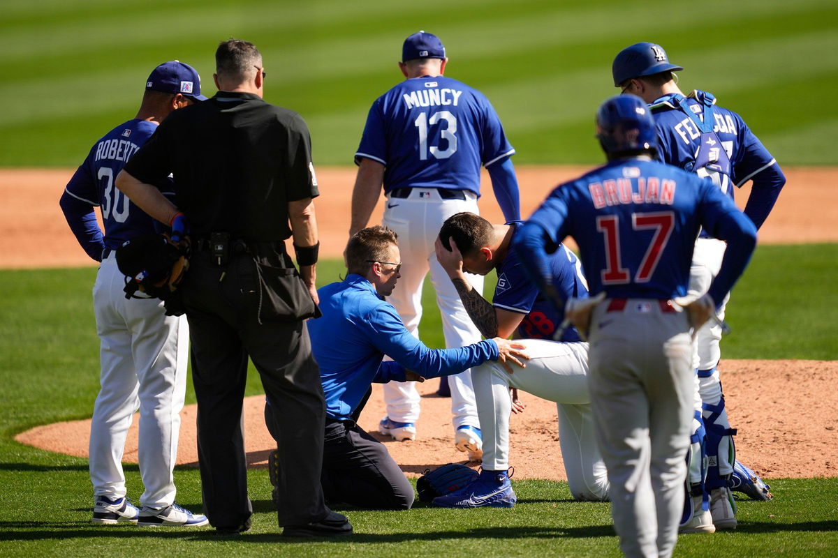 <i>Ashley Landis/AP via CNN Newsource</i><br/>Bobby Miller received medical attention after being hit in the head by a line drive during the Los Angeles Dodgers' Spring Training game against the Chicago Cubs.