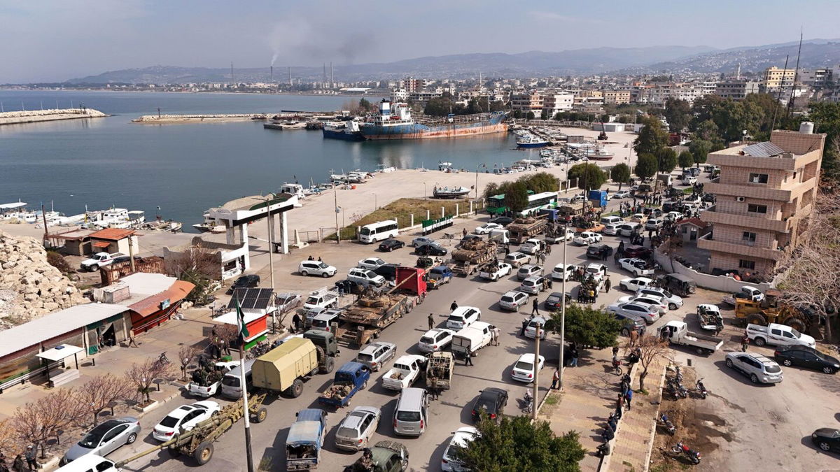 <i>Ali Haj Suleiman/Getty Images via CNN Newsource</i><br/>Syrian government fighters line a roadway in Baniyas