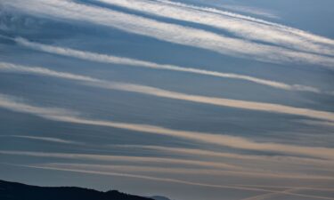 Jet contrails are viewed in the sky as the first significant rainfall is about to move into the Central Coast on March 27
