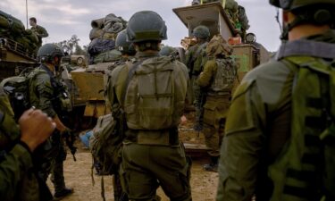 Reservists prepare their belongings before entering Gaza at a staging point near the Gaza border