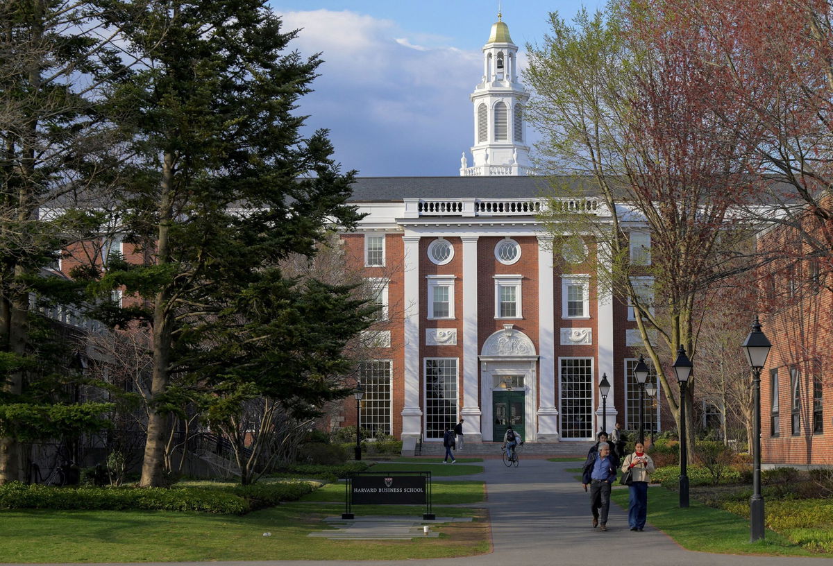 People walk on the business school campus of Harvard University in Cambridge