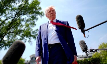 US President Donald Trump speaks to members of the media before boarding Marine One on the South Lawn of the White House on Tuesday in Washington