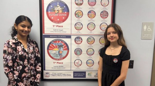 <i>WFTS via CNN Newsource</i><br/>Eighth-grader Lauren McGee and seventh-grader Mahi Patel were among hundreds of elementary and middle school students across the county to accept Latimer’s challenge to create a “Future Voter” sticker that would encourage young people to learn more about voting and elections.