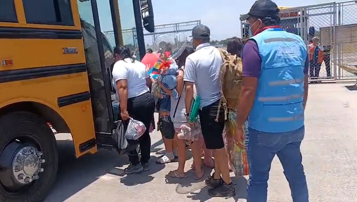 <i>CNN via CNN Newsource</i><br/>Migrants who self-deported from the US board a bus in Honduras after landing at a local airport.