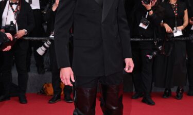 The sky-high leather boots were designed by Saint Laurent.