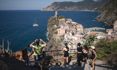Tourists look out from a hillside in Vernazza in the Cinque Terre National Park