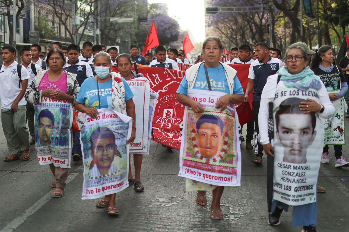 <i>Raquel Cunha/Reuters/File via CNN Newsource</i><br/>Students follow relatives of the 43 missing students of Ayotzinapa Rural Teachers' College and members of collectives of relatives of missing persons during the Ayotzinapa's monthly march to demand justice in Mexico City
