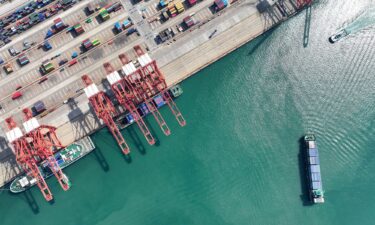 A container ship waits to berth at the port in Lianyungang