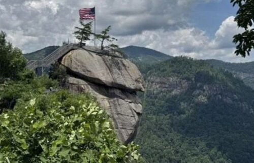 An American flag sits at the top of Chimney Rock State Park.