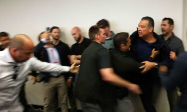 Sen. Alex Padilla is pushed out of the room as Homeland Security Secretary Kristi Noem holds a news conference regarding the recent protests in Los Angeles on June 12.