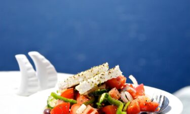 Greek salad is known as "village salad" in Greece. It includes tomatoes and a wedge of feta.
