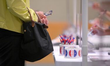 A poll clerk assists a voter to register at a polling station set up inside The Metropolitan Museum of Art on New York's Primary Election Day