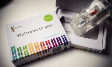 This illustration picture shows a saliva collection kit for DNA testing displayed in Washington