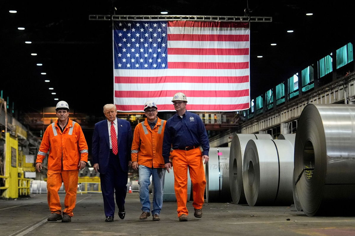 <i>Julia Demaree Nikhinson/AP via CNN Newsource</i><br/>President Donald Trump walks with workers as he tours U.S. Steel Corporation's Mon Valley Works-Irvin plant