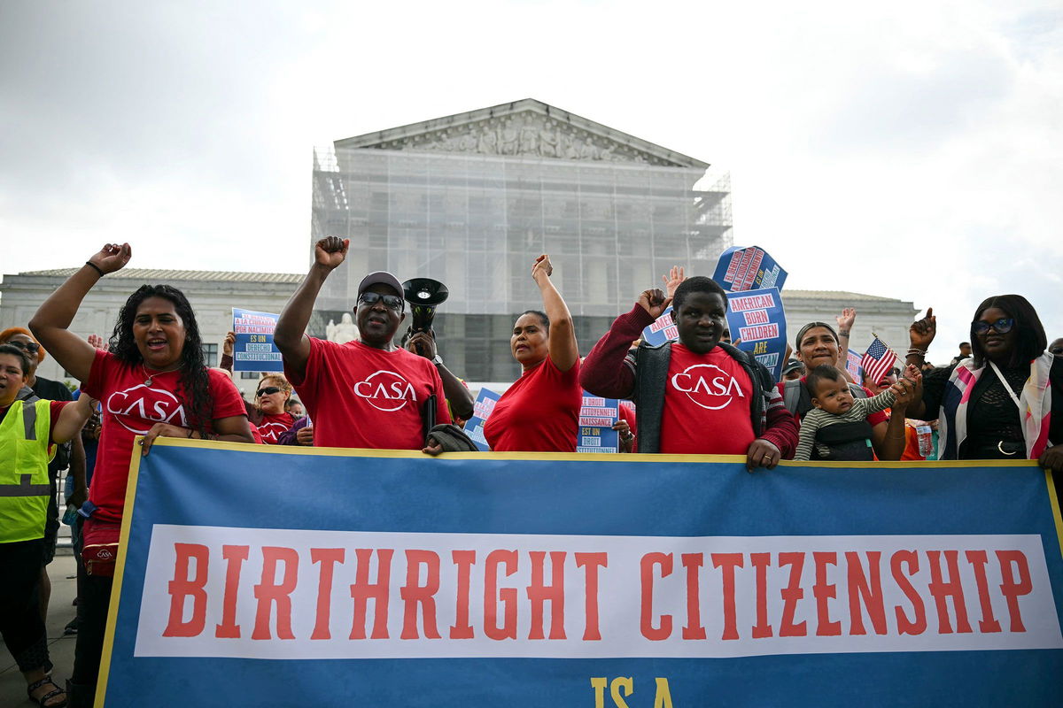 <i>Drew Angerer/AFP/Getty Images via CNN Newsource</i><br/>People hold a banner as they participate in a protest outside the US Supreme Court over President Donald Trump's move to end birthright citizenship as the court hears arguments over the order in Washington