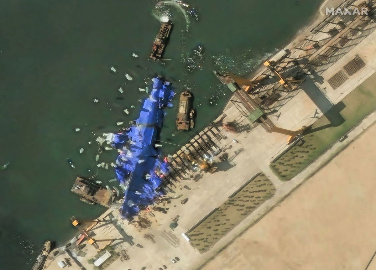 <i>Maxar/DigitalGlobe/Getty Images via CNN Newsource</i><br/>Maxar imagery shows continued efforts to conceal the damaged destroyer at Hambuk Shipyard one day after the failed launch.