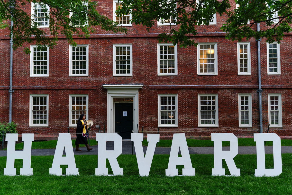 <i>Sophie Park/Bloomberg/Getty Images via CNN Newsource</i><br/>A students walks past a display on the Harvard University campus in Cambridge