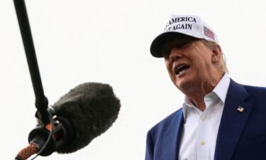 President Donald Trump speaks to members of the media during the installation of a new flagpole on the South Lawn at the White House.